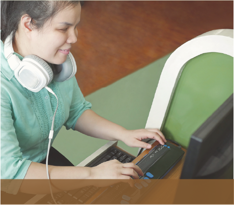 Blind woman using assistive technology at a computer