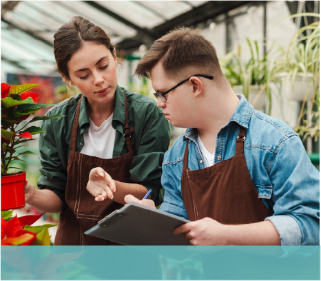 Young man and woman working in a greenhouse